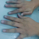 The hands of the workerswho sew denim shirts have turned blue.